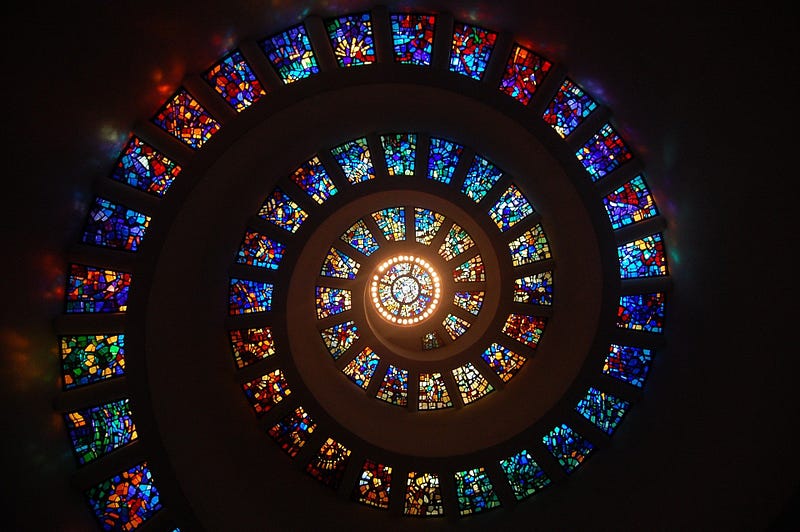 Stained glass design spiraling upward.