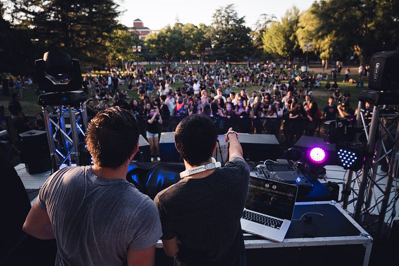Two DJ’s playing for a crowd.