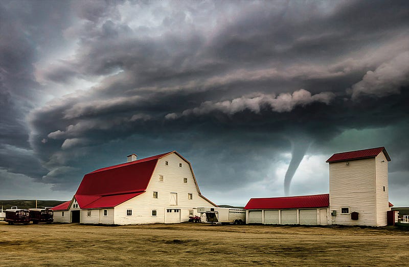 A tornado approaches a farm.