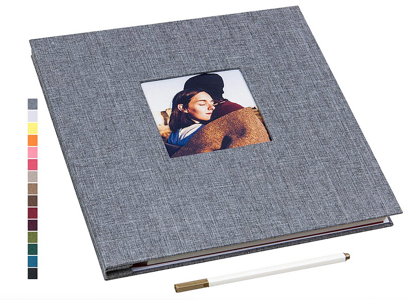 A gray scrapbook with a photo in the center of a couple hugging.l
