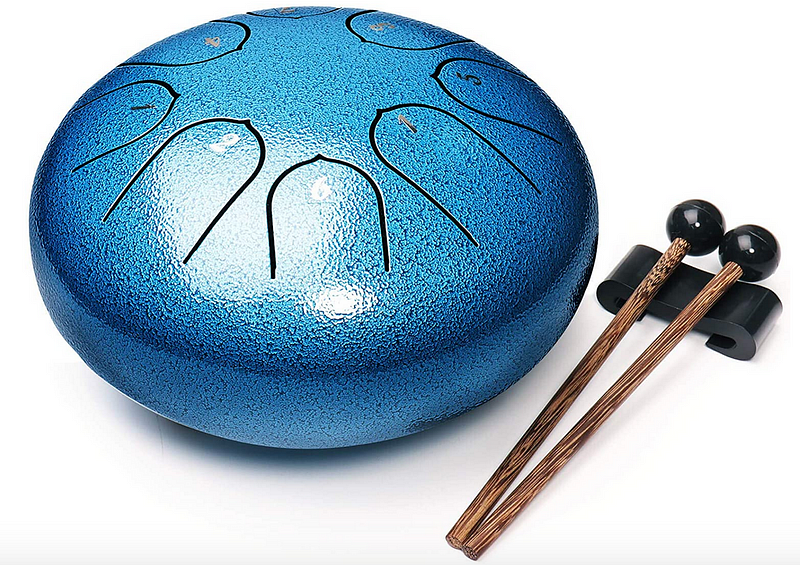 A blue steel tongue drum with a pair of drumsticks.